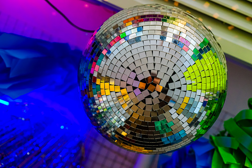 Disco ball. Purple, yellow, green, and blue light. Bottom view.