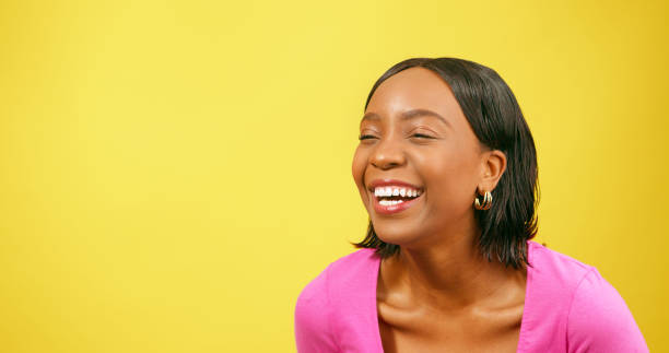 istock Laughing young woman, Black beautiful, yellow background studio 1693792501
