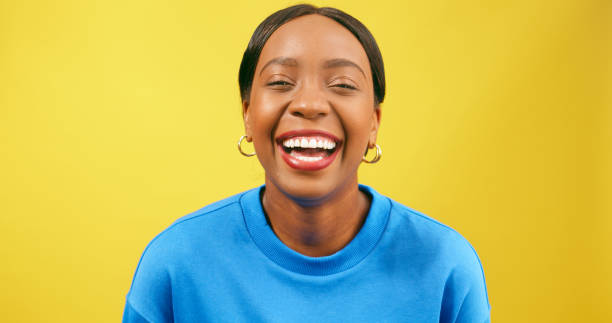 istock Laughing young woman, Black beautiful, yellow background studio 1693793124