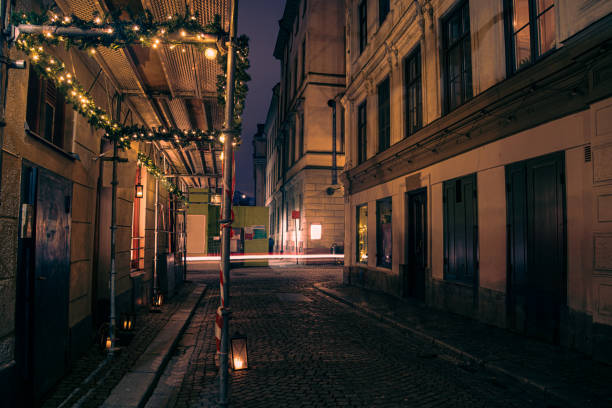 istock Empty alley amidst buildings in city at night 1693795246