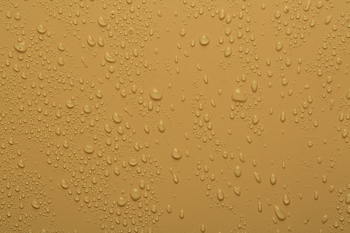 Water drops on orange color  surface
