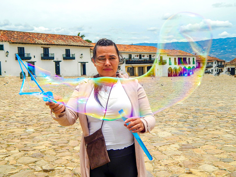 Woman doing bubbles with a bubbles toy