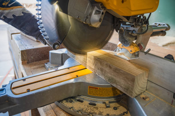 istock Builder saws a board with a circular saw in the cutting a wooden plank 1693801278