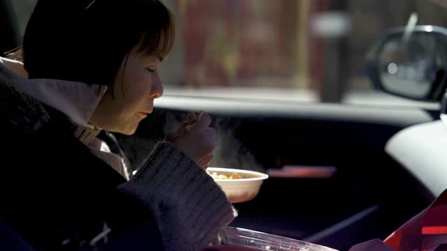 Asian woman quick car lunch while travelling Japan