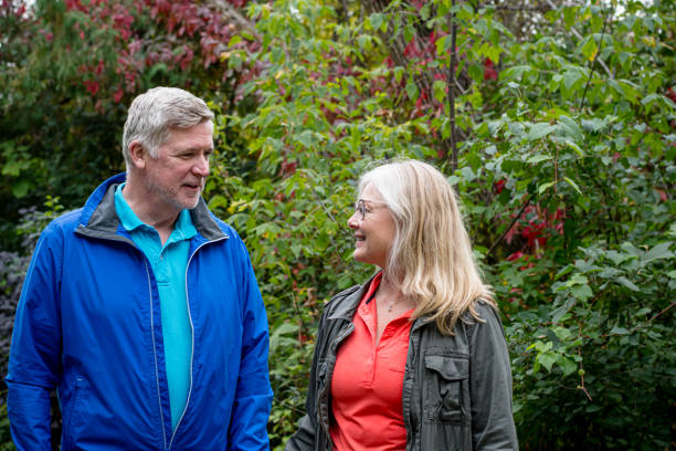 istock Autumn's Rebirth: Couple Strolls Hand in Hand Through Lush Park Trail Post-Illness 1693816108