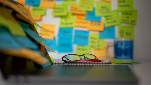 istock blurred colorful post note background with computer notebook and glasses, concept of working on memo note memorandum in office, reminder messages for working schedule, things to do list 1693822372