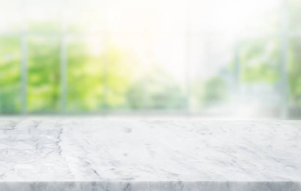 istock Selective focus.Marble table top on blur abstract window glass background.For montage product display 1693838544