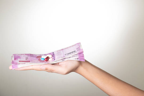 istock Medicine with rupees in hand on white background 1693858199