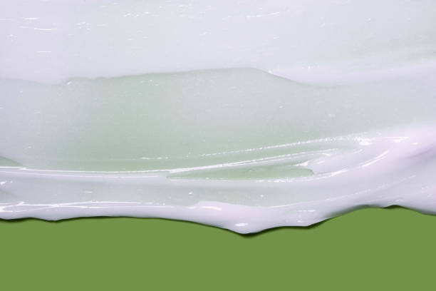 istock White cosmetic mask or cleansing foam swatch smudge texture green background 1693867802