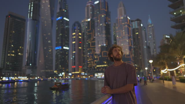 Man walking in Dubai Marina at sunset