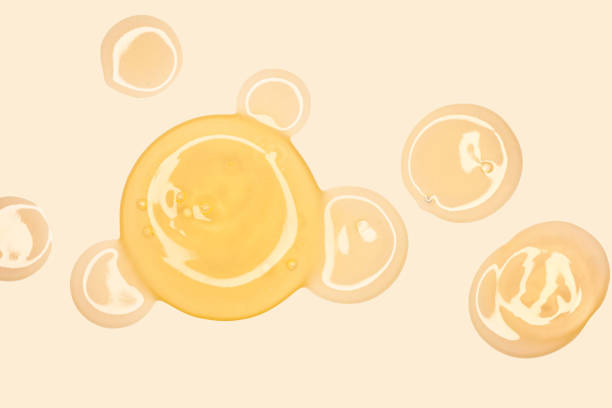 istock Orange drops circles cosmetic mask or cleansing foam swatch smudge texture light background 1693870727