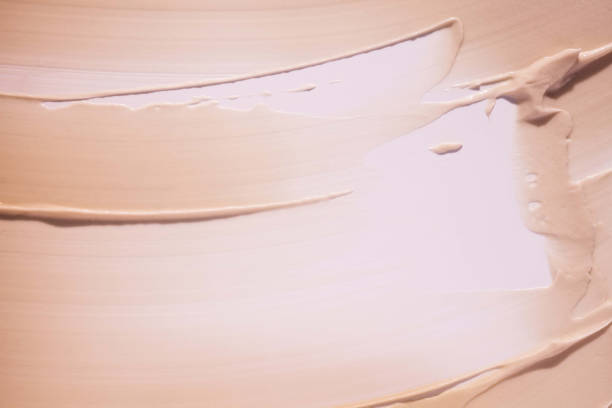 istock Beige light pink cosmetic mask or cleansing foam swatch smudge texture background 1693872728
