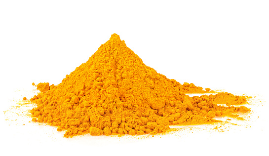 Pile of turmeric powder isolated on a white background. Curcuma aromatica, Indian spice.