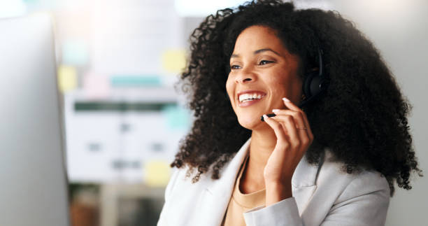 istock Happy female customer service agent smiling while working in a call centre, talking to a client with a headset. A helpful saleswoman assisting customers with purchase orders and questions online 1693885131