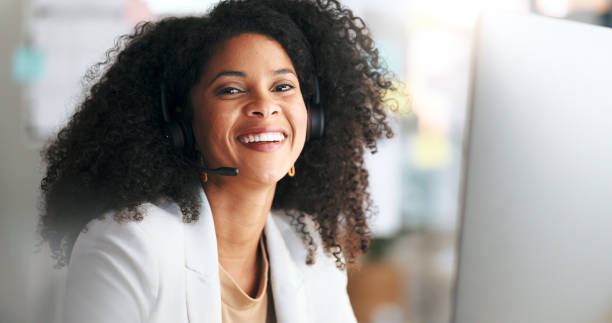 istock Call center or customer support agent looking happy while wearing headphones and working inside. Portrait of a laughing remote worker enjoying her job, offering great service and explaining products 1693885137