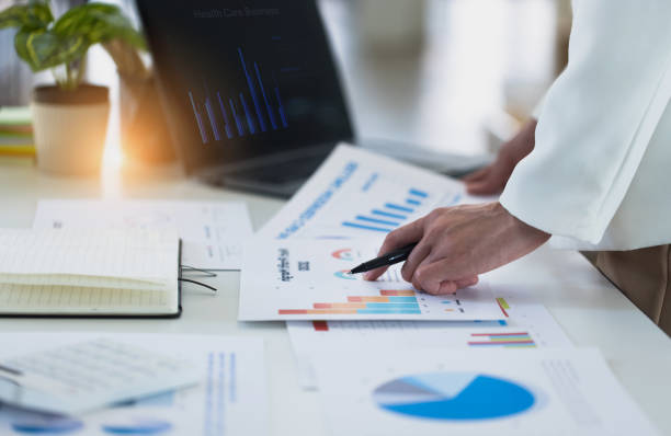 istock Business hands with business financial documents. 1693899682