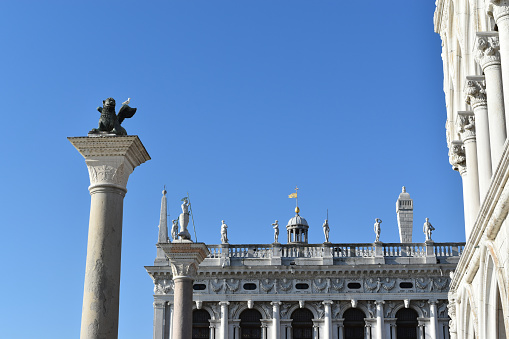 The Lion of Venice, the statue of Saint Theodore, the facade of  Marciana Library in St Mark's Square, Venice, Italy.
