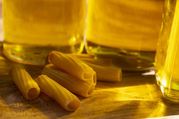 pasta seen through reflections of oil bottles