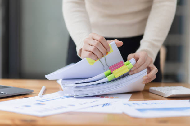 istock Businesswoman hands working with document papers. 1693924107