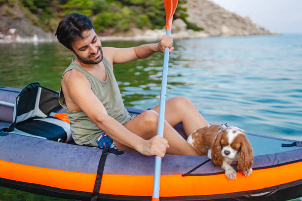 istock Adult man enjoys canoeing with his dog 1693951231