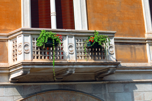 Balcony with flowers on the facade of a building