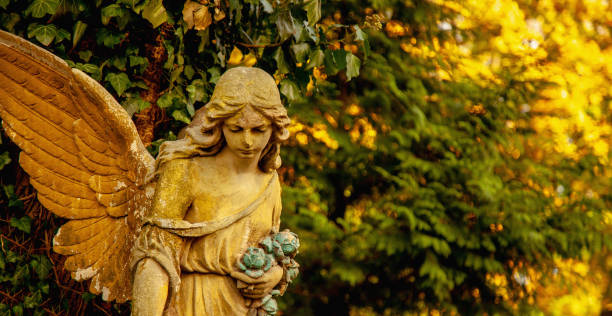 istock Guardian angel statue in sunlight. Free copy space for design or text. Horizontal image. 1693988516