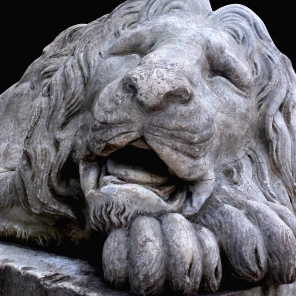 istock Ancient stone statue of lion. Close up. 1693989170