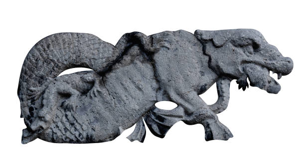 istock Dragon bites another little dragon. An ancient stone statue. 1693989719