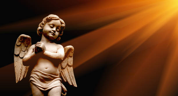 Little beautiful guardian angel statue in sunlight as a symbol of strength, truth and faith. Horizontal image. Little beautiful guardian angel statue in sunlight as a symbol of strength, truth and faith. Horizontal image. pics of guardian angels stock pictures, royalty-free photos & images