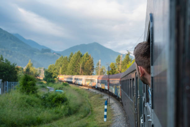 istock Man traveling by railway through Balkans. Handsome young guy looking out the train window. Tourist male traveller 1693997079