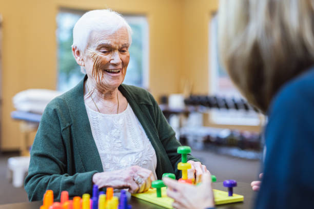 istock Elderly woman at occupational therapy appointment 1694001646