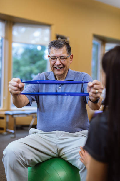 istock Cheerful senior man at physical therapy appointment 1694002202