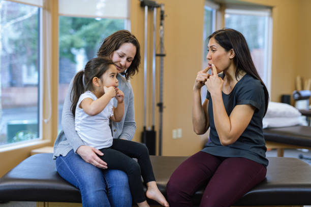 istock Young girl at speech therapy appointment with her mom 1694002755