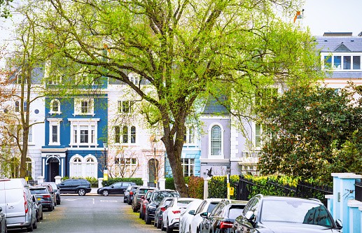 Large townhouses on a street in Notting Hill, West London. Photographed during early spring.