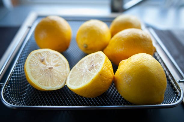 istock Fresh lemons in a tray on a table. Citrus fruit concept 1694044746