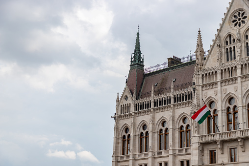 A picture of a portion of the Hungarian Parliament Building against a cloudy sky.