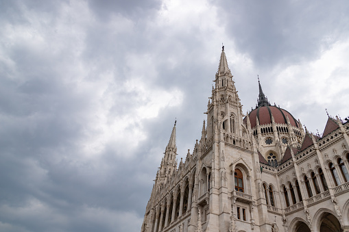 A picture of a portion of the Hungarian Parliament Building against a cloudy sky.