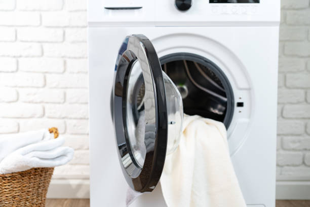 istock Modern white washing machine in a laundry room 1694054818