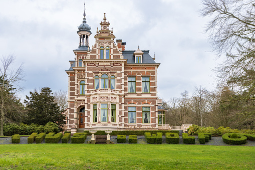 Haren, The Netherlands - March 20, 2023: Mansion House De Wolf in Haren with ornamental boxwood in municipality Groningen in The Netherlands