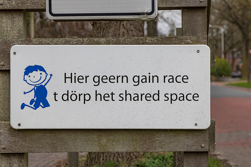 Onnen,The Netherlands - March 20, 2023: Warning sign with text in dialect to limit speed in village Onnen Municipality Groningen in Groningen province The Netherlands