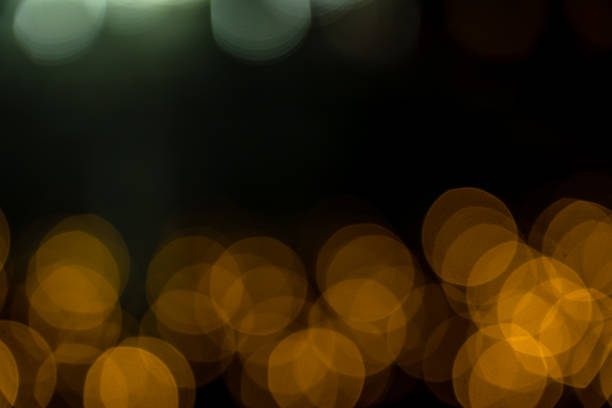 istock Romantic lights on Christmas decorations on black background. Defocused 1694067532