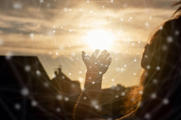 Concepts of network integration with nature and the real world. A woman shows a net against the backdrop of a sunset.