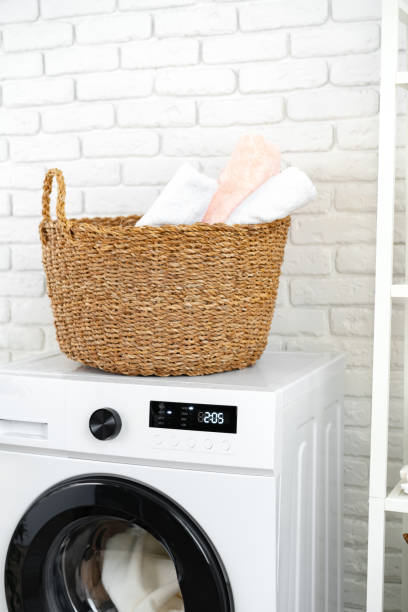 istock Laundry basket on washing machine in a laundry room 1694078038