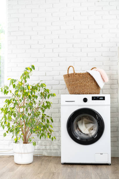 istock Laundry basket on washing machine in a laundry room 1694081939