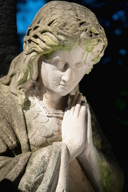 istock Beautiful praying angel. An ancient stone statue. 1694084091