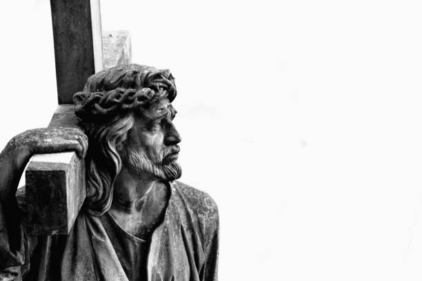istock Holy cross with  Jesus Christ. Ancient stone statue. 1694085744
