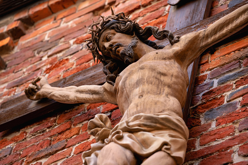 The crucifixion of Jesus Christ. Antique statue. Horizontal image. Religion concept.