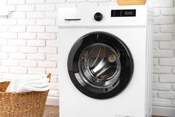 istock Washing machine and basket in a laundry room 1694087390