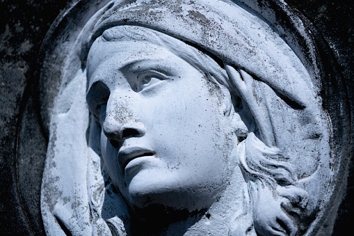 A copy of the plaster ancient Greek bust of Aphrodite on a dark background