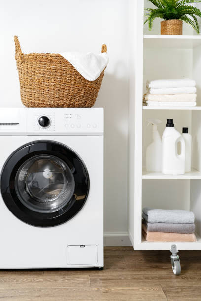 istock Laundry room with washing machine and basket with laundry 1694099202